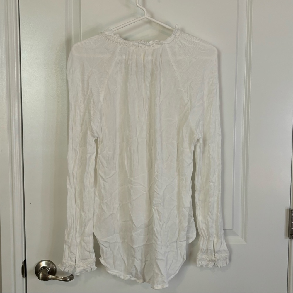 White ruffled floral print blouse.